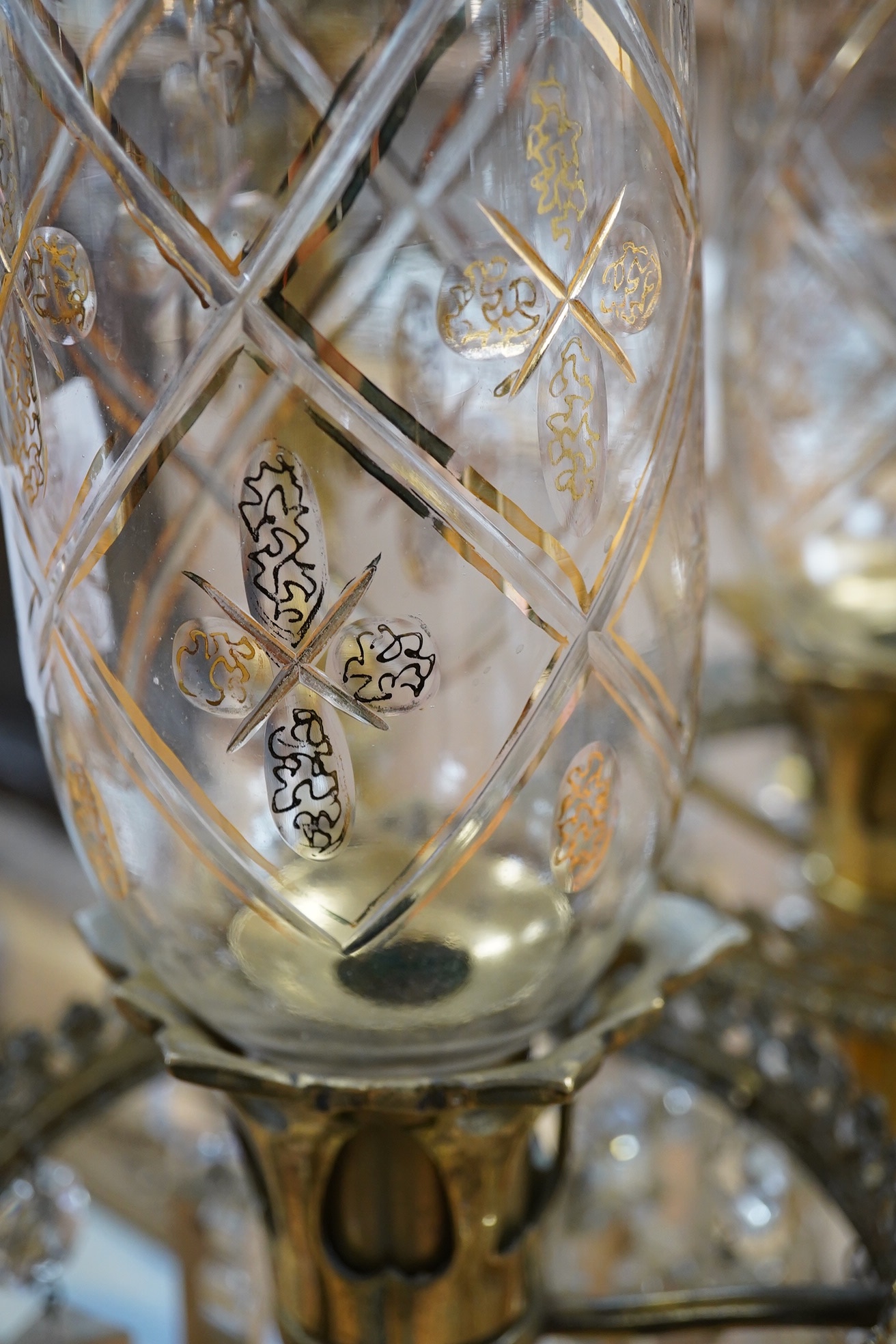 A pair of brass table lustres with storm shades, overall 63cm high, drops 21/26cm long. Condition- good